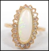 A yellow gold substantial opal and diamond cluster ring complete in the presentation case