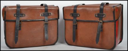 A pair of vintage 20th century side saddle bike panniers of leather construction. Measurements: 26