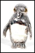 A contemporary and unusual 20th century silver novelty figure of a penguin having glass eyes