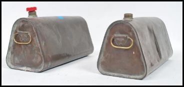 A pair of large Industrial copper water bottles in brass, each of tapering form with threaded caps (