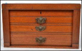 An Edwardian period oak campaign style cutlery canteen with sunken brass handles, lift up top and