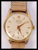 A vintage mid century good Roamer Gents wristwatch in yellow metal having dagger batons with lower