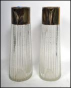 A pair of early 20th century silver plated and dimple glass Claret jugs, the glass bodies of