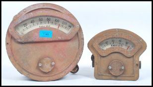 2 20th century Industrial large bulkhead volt and ampere meters. Each with white dials in heavy