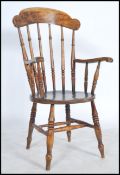 A Victorian beech and elm Windsor chair having a saddle seat and turned bobbin rail back.