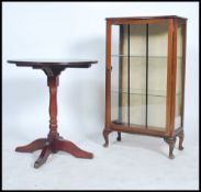 A 20th century china display cabinet having shaped serpentine front raised on cabriolet legs with