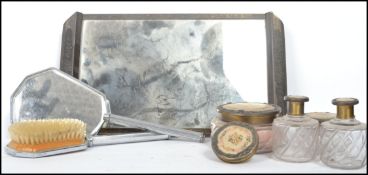 An art deco vanity set to include a brush, mirror, powder puff and perfume / scent bottles. measures