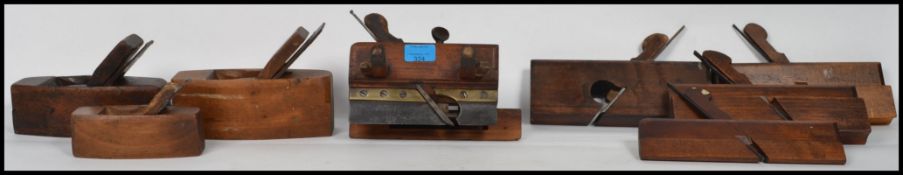 A collection of vintage woodworking planes to include a plough plane, coffin planes, and wooden