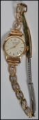 A vintage 9ct gold ladies watch ( serial number 311098 ) by record in the original case on a