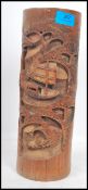 A 19th century carved wooden brush pot of cylindrical form having a carved decoration depicting