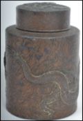 An early 20th Century Chinese tea caddy of small proportions in metal with detailing of a dragon