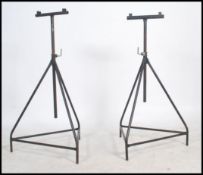 A pair of vintage industrial 20th century adjustable tubular props, constructed from tri - pod