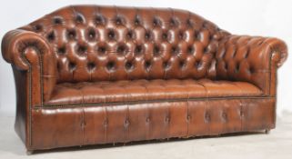 An antique style Chesterfield sofa settee in tan brown leather being button back to the seat and