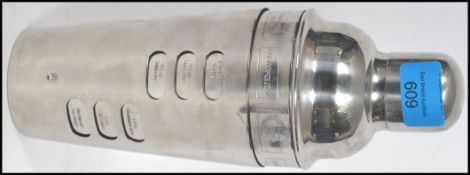 A stunning 20th century white metal cocktail shaker of usual form having a revolving outer sleeve