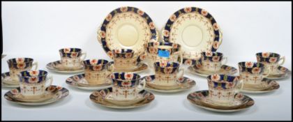 A 20th century 12 person ceramic tea  / dinner service by Stanley China to include cups, saucers,