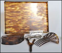 A collection of early 20th century tortoise shell lucite wares to include a tray, hair grip with