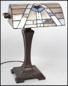 A Tiffany style bankers lamp having an ornate deco