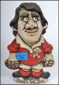 A vintage rugby union memorabilia Grogg figurine of Wales player Jones the Jinx with signature for