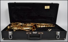 A 500 series saxophone musical instrument having mother of pearl buttons, mouth piece etc. Ser No
