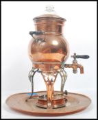 A 20th century brass samovor / coffee peculator, tap to the front raised on tri-pod feet with