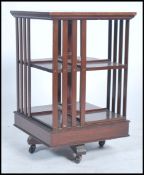 An Edwardian mahogany inlaid revolving bookcase having slatted form with section revolving
