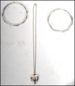 A pair of solid silver hallmarked bangles with different patterns hallmarked for Birmingham 1980