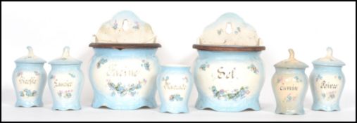 A set of 7 19th century French kitchen canisters to include two wall mounted with wooden lids