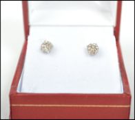 A pair of 14ct white gold and diamond stud earrings of approx 83 points complete in the presentation
