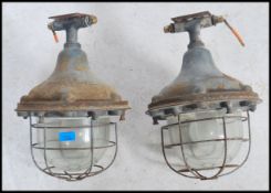 A pair of large 20th century retro industrial bulkhead lights of metal construction having large