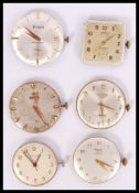 A good collection of wristwatch movements and faces to include a gold Omega with faceted hands and