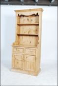 A good antique style country pine welsh dresser. The base with  cupboard and short drawers having