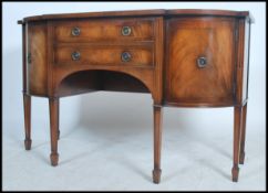 A good 20th century Regency style serpentine front sideboard having an arrangement of drawers and