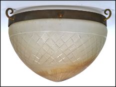 An early 20th century Art Deco glass and brass ceiling light fixture, having a brass three point