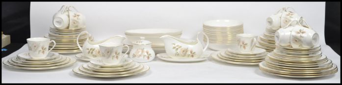 An extensive Royal Doulton twelve person setting dinner service in the ' Yorkshire Rose ' pattern