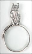 A contemporary decorative ladies silver necklace pendant in the form of a magnifying glass having