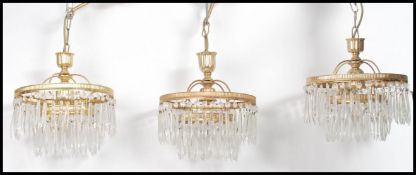 A set of 3 20th century gilt metal ormulu rococo empire revival chandeliers, each with faced cut