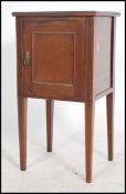 An Edwardian mahogany inlaid pot cupboard being raised on square tapered legs with single locker