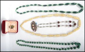 A group of vintage costume jewellery to include a gold plated and enamel owl, moss agate bead