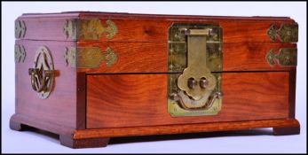 A vintage 20th century Oriental Chinese jewellery box of mahogany construction with brass edge