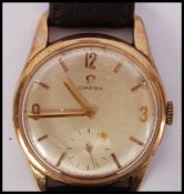 A vintage gents mid century 9ct gold / 375 hallmarked Omega wristwatch having baton numerals with