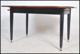 A G-plan Librenza pattern large rectangular extending dining table raised on ebonized legs and