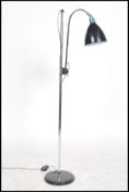A retro 20th century anglepoise standard lamp raised on a ebonised circular base with an