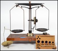 A 20th century set of balance scales raised on a wooden plinth having ivorine plaque for W and J