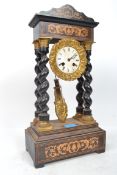 A French ormolu mounted ebonised portico mantel clock, 19th century, the silvered dial enclosing a
