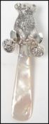 A good silver babies rattle in the form of a bear with adorned bells and a shaped handle / teether (