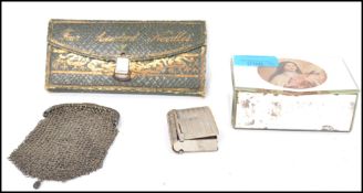 A silver white metal chain mesh ladies purse along with a silver white metal vesta case in the