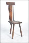 A 19th century Victorian Welsh spinning chair raised on tapering tripod legs with Celtic knot carved