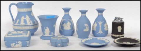 A collection of Wedgwood jasper cameo ware to include a pair of vases, jug, pot and pin dishes.