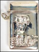 A silver white metal match Vesta having a mermaid in relief to the front, hinged top opening.