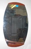 A retro teak wood frameless atomic / sputnik style wall mirror of lozenge form dating to the 1970'